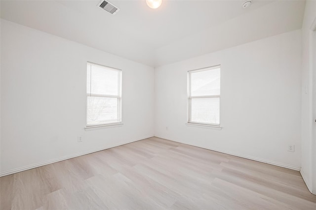8310 Remington Bluff Ln, Richmond, TX 77407 - spare room featuring plenty of natural light, wood finished floors, and a smoke detector