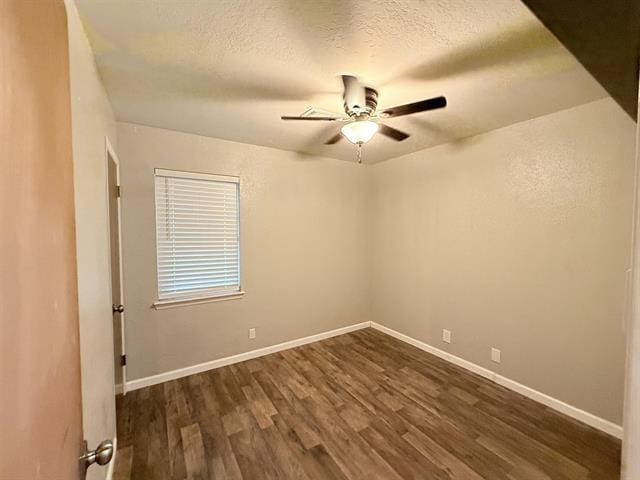 9410 Guy Cir, Beaumont, TX 77707 - spare room featuring dark wood-type flooring, ceiling fan, a textured ceiling, and baseboards
