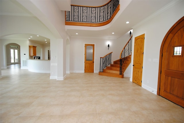 504 High Meadow Ranch Dr, Magnolia, TX 77355 - entryway featuring arched walkways, recessed lighting, a towering ceiling, stairway, and crown molding