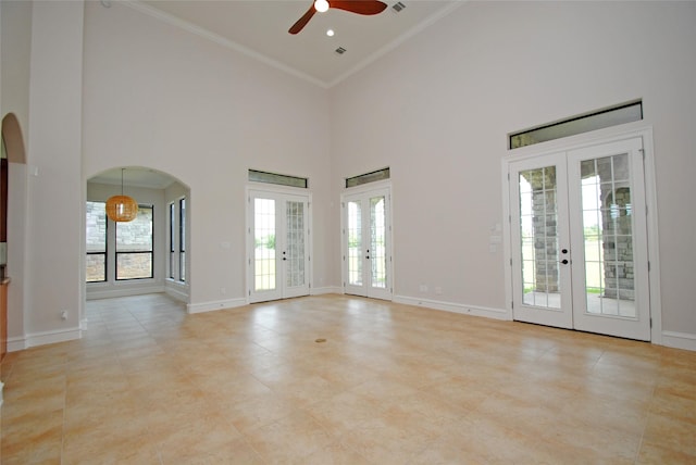 504 High Meadow Ranch Dr, Magnolia, TX 77355 - spare room featuring french doors, a ceiling fan, arched walkways, high vaulted ceiling, and crown molding