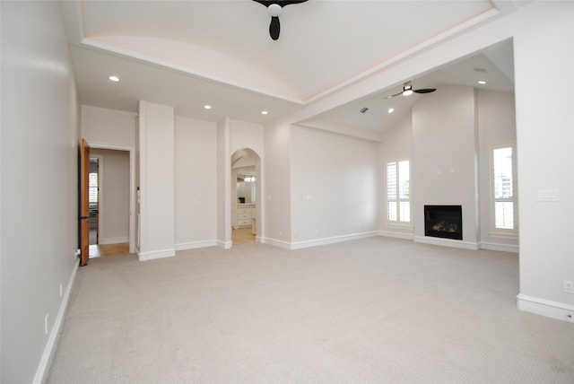 504 High Meadow Ranch Dr, Magnolia, TX 77355 - unfurnished living room with a ceiling fan, arched walkways, light colored carpet, recessed lighting, and a fireplace