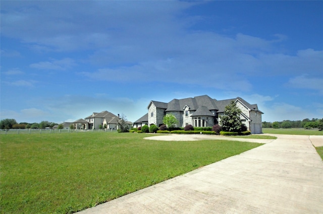504 High Meadow Ranch Dr, Magnolia, TX 77355 - french provincial home featuring driveway, a front yard, stone siding, and a garage