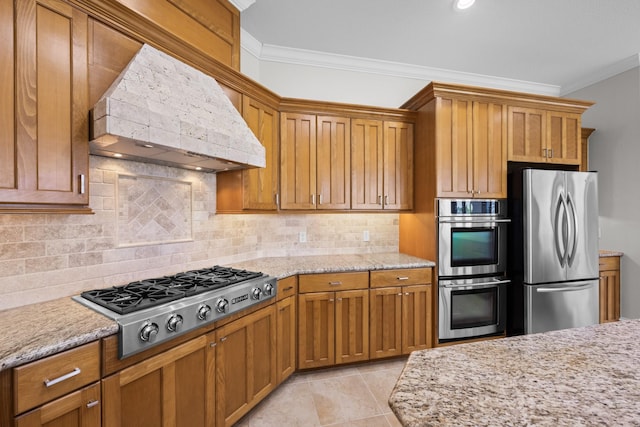 504 High Meadow Ranch Dr, Magnolia, TX 77355 - kitchen featuring appliances with stainless steel finishes, custom range hood, crown molding, brown cabinetry, and backsplash