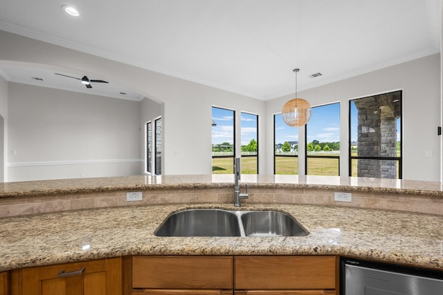 504 High Meadow Ranch Dr, Magnolia, TX 77355 - kitchen with brown cabinets, dishwasher, ornamental molding, light stone counters, and decorative light fixtures