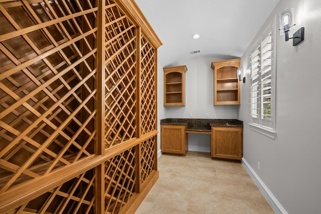 504 High Meadow Ranch Dr, Magnolia, TX 77355 - wine cellar featuring built in desk, lofted ceiling, light tile patterned floors, and recessed lighting