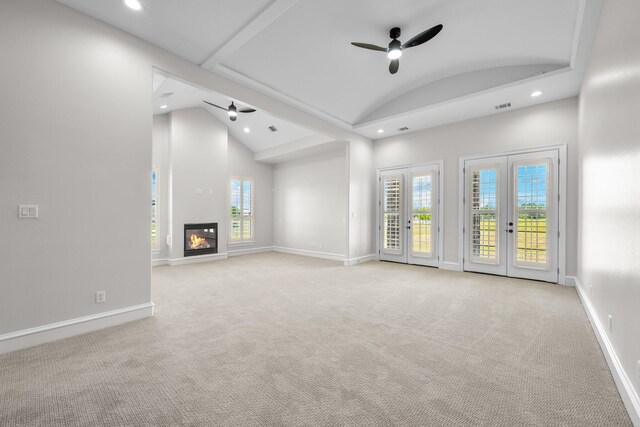 504 High Meadow Ranch Dr, Magnolia, TX 77355 - unfurnished living room featuring ceiling fan, recessed lighting, light carpet, a glass covered fireplace, and french doors