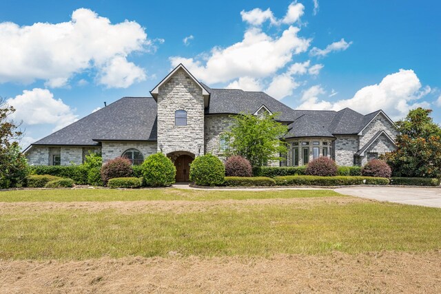 504 High Meadow Ranch Dr, Magnolia, TX 77355 - french country home featuring stone siding and a front lawn