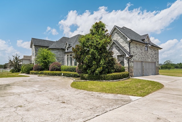 504 High Meadow Ranch Dr, Magnolia, TX 77355 - french provincial home featuring stone siding, concrete driveway, a garage, and a front lawn