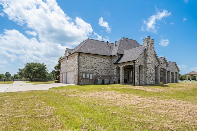 504 High Meadow Ranch Dr, Magnolia, TX 77355 - rear view of property with concrete driveway, a chimney, a garage, brick siding, and roof with shingles