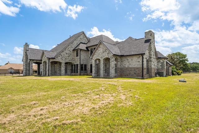 504 High Meadow Ranch Dr, Magnolia, TX 77355 - view of front of home with a chimney, stone siding, and roof with shingles