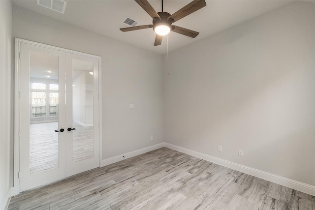 17020 Sweet Iris Ct, Conroe, TX 77302 - spare room featuring light wood-style floors, a ceiling fan, baseboards, and french doors