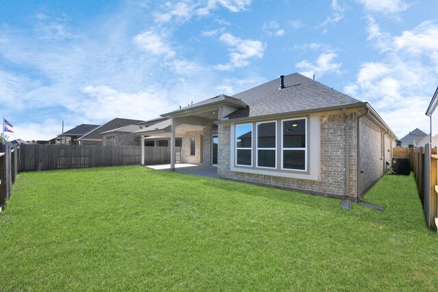 20922 Whirlaway Green Cir, Tomball, TX 77377 - rear view of house featuring brick siding, central air condition unit, a patio, and roof with shingles