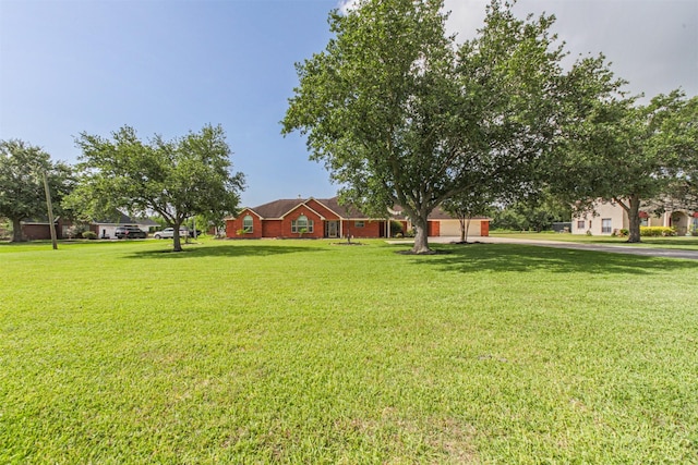 4222 Skylane Rd, Beach City, TX 77523 - view of grassy yard with driveway and an attached garage