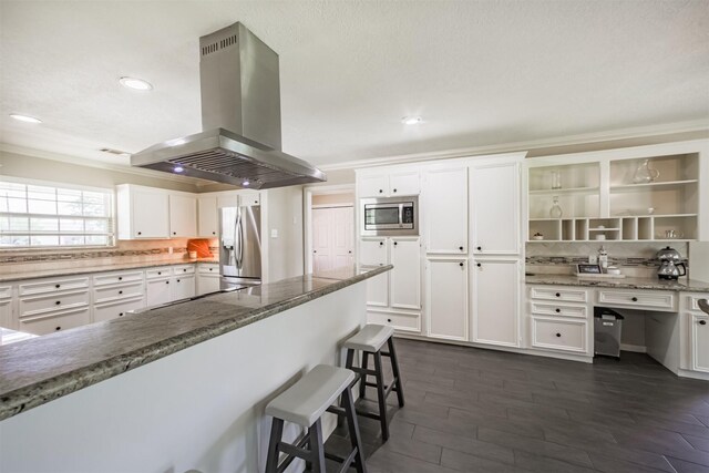 4222 Skylane Rd, Beach City, TX 77523 - kitchen featuring stainless steel appliances, island exhaust hood, light stone countertops, white cabinets, and ornamental molding