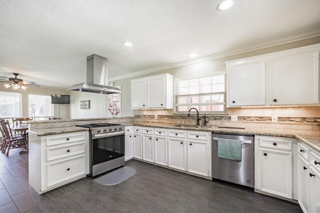4222 Skylane Rd, Beach City, TX 77523 - kitchen featuring stainless steel appliances, island exhaust hood, a sink, a peninsula, and ornamental molding