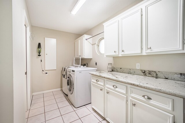 4222 Skylane Rd, Beach City, TX 77523 - laundry room featuring cabinet space, washer and clothes dryer, light tile patterned floors, and baseboards