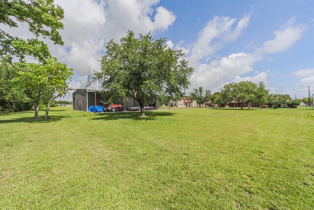 4222 Skylane Rd, Beach City, TX 77523 - view of green lawn with an outbuilding and a pole building