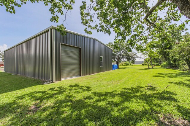 4222 Skylane Rd, Beach City, TX 77523 - view of grassy yard featuring a detached garage and an outbuilding