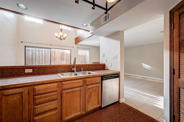 2011 Converse St, Houston, TX 77006 - kitchen featuring dishwasher, a sink, tile patterned floors, brown cabinetry, and recessed lighting