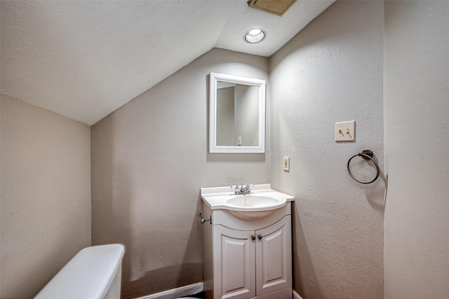 2011 Converse St, Houston, TX 77006 - half bathroom with vaulted ceiling, vanity, toilet, and a textured wall