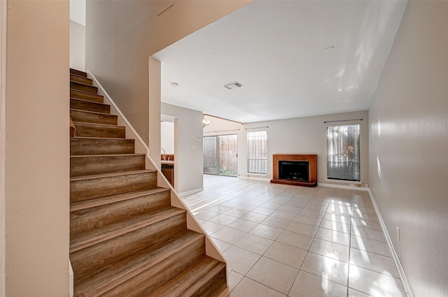 2011 Converse St, Houston, TX 77006 - stairway featuring tile patterned flooring, baseboards, and a fireplace with raised hearth