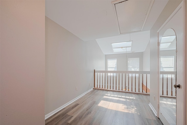 2011 Converse St, Houston, TX 77006 - empty room with attic access, healthy amount of natural light, wood finished floors, and baseboards