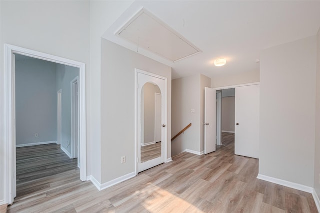 2011 Converse St, Houston, TX 77006 - spare room with attic access, light wood-type flooring, and baseboards