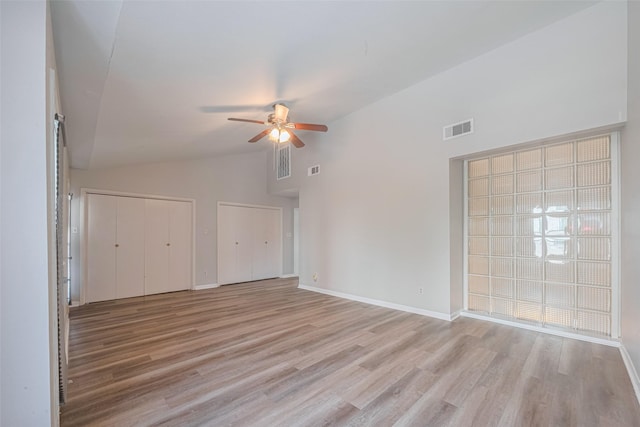 2011 Converse St, Houston, TX 77006 - empty room featuring ceiling fan, high vaulted ceiling, light wood-style floors, and baseboards