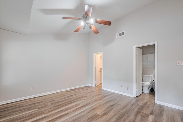 2011 Converse St, Houston, TX 77006 - unfurnished bedroom featuring wood finished floors, ensuite bath, baseboards, a high ceiling, and a ceiling fan