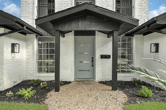 5702 Indigo St, Houston, TX 77096 - view of exterior entry with a balcony and brick siding