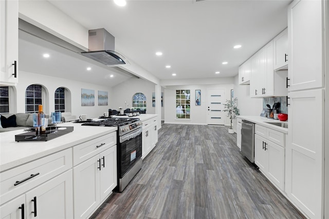5702 Indigo St, Houston, TX 77096 - kitchen featuring appliances with stainless steel finishes, island exhaust hood, recessed lighting, dark wood-type flooring, and light countertops