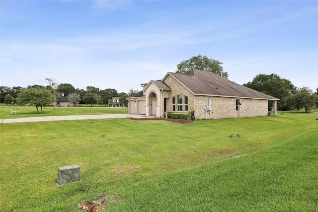 10025 Jason Ct, Beaumont, TX 77705 - view of home's exterior featuring concrete driveway, a yard, a garage, and brick siding