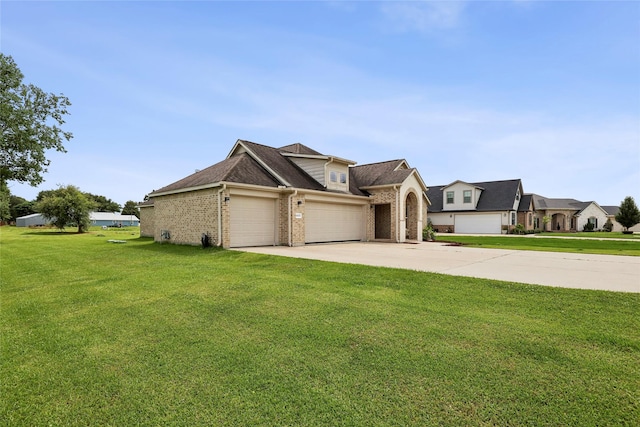 10025 Jason Ct, Beaumont, TX 77705 - view of front facade featuring a garage, a front lawn, brick siding, and concrete driveway