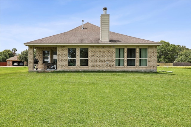 10025 Jason Ct, Beaumont, TX 77705 - back of property with brick siding, a chimney, and a shingled roof