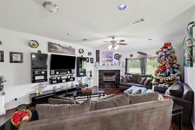 10025 Jason Ct, Beaumont, TX 77705 - living area featuring dark wood-type flooring, a tiled fireplace, and ceiling fan