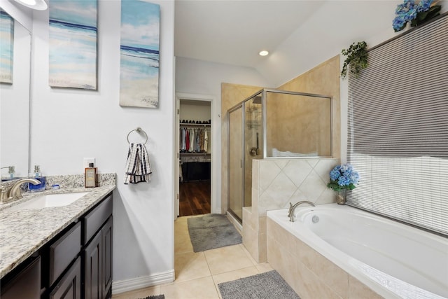 10025 Jason Ct, Beaumont, TX 77705 - bathroom featuring a garden tub, a stall shower, vanity, tile patterned floors, and a walk in closet