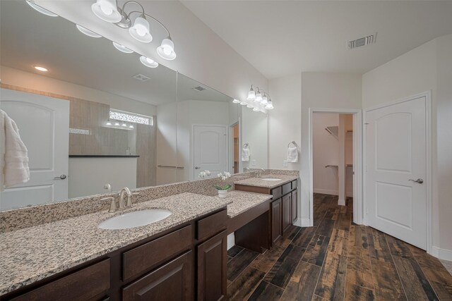 430 Seaside Sparrow Way, Richmond, TX 77469 - bathroom with double vanity, wood finished floors, and a walk in closet