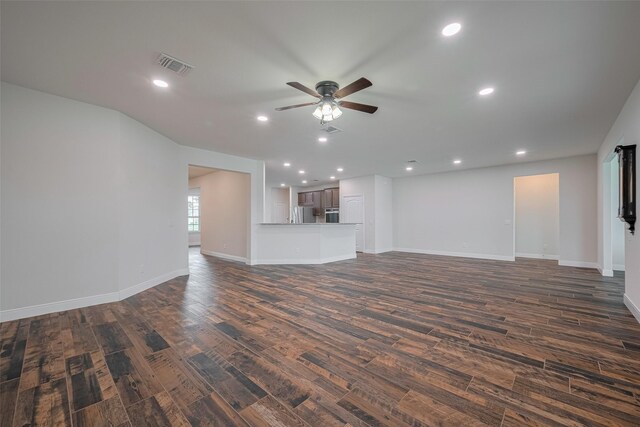 430 Seaside Sparrow Way, Richmond, TX 77469 - unfurnished living room with dark wood-style flooring, a ceiling fan, and recessed lighting