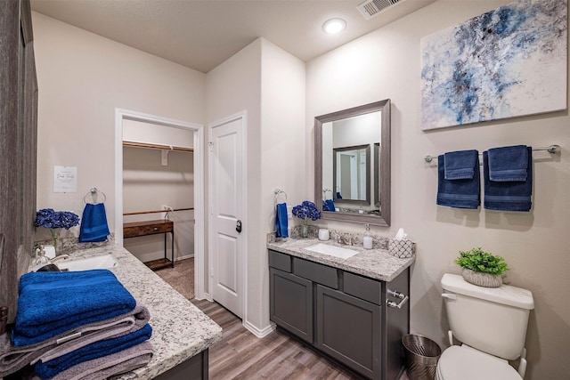 907 Crystal River Rd, Conroe, TX 77316 - bathroom featuring vanity, wood finished floors, and recessed lighting