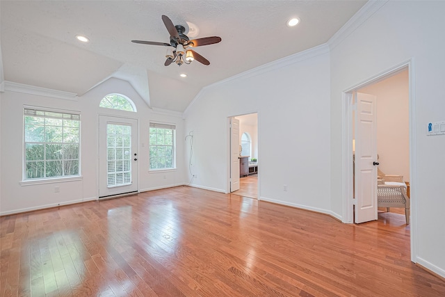 26 Skyland Pl, The Woodlands, TX 77381 - unfurnished living room featuring a ceiling fan, light wood finished floors, ornamental molding, and lofted ceiling