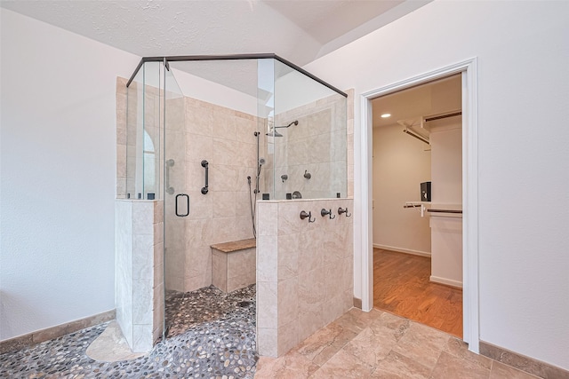 26 Skyland Pl, The Woodlands, TX 77381 - full bathroom featuring a stall shower and a spacious closet