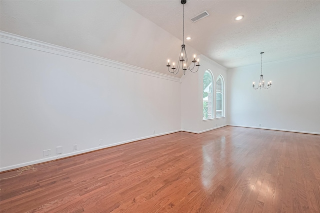26 Skyland Pl, The Woodlands, TX 77381 - spare room with a chandelier, ornamental molding, light wood finished floors, a textured ceiling, and recessed lighting