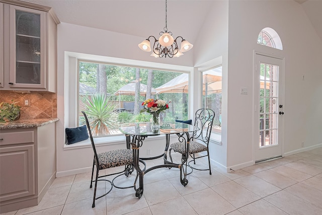26 Skyland Pl, The Woodlands, TX 77381 - dining area with a chandelier, light tile patterned floors, and high vaulted ceiling