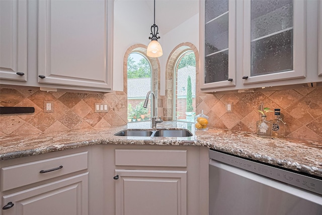 26 Skyland Pl, The Woodlands, TX 77381 - kitchen with dishwasher, glass insert cabinets, backsplash, light stone countertops, and white cabinets