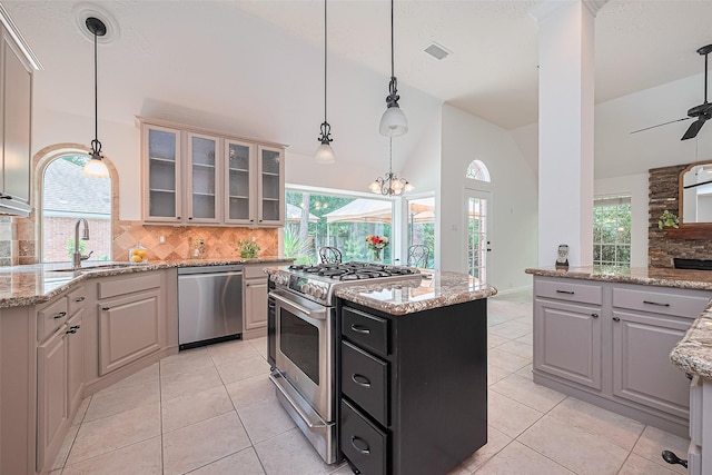26 Skyland Pl, The Woodlands, TX 77381 - kitchen with appliances with stainless steel finishes, backsplash, light tile patterned floors, vaulted ceiling, and glass insert cabinets