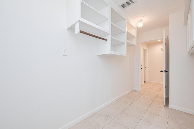 26 Skyland Pl, The Woodlands, TX 77381 - corridor featuring light tile patterned flooring and baseboards