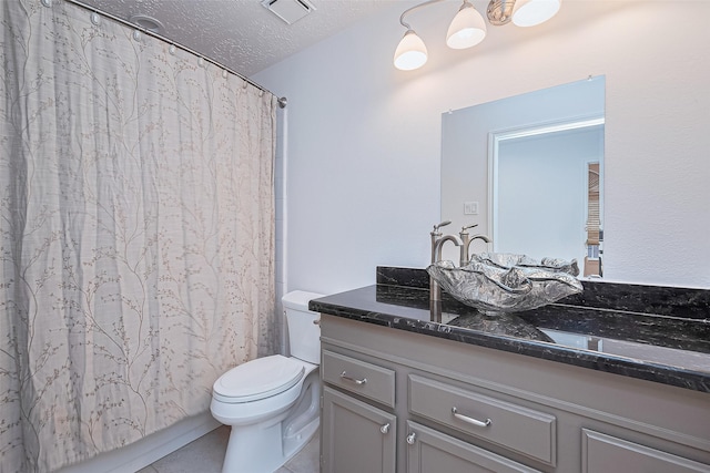 26 Skyland Pl, The Woodlands, TX 77381 - full bathroom with vanity, a textured ceiling, a shower with shower curtain, and tile patterned floors