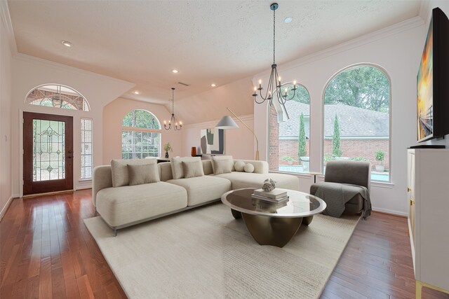 26 Skyland Pl, The Woodlands, TX 77381 - living area with a chandelier, hardwood / wood-style flooring, ornamental molding, a textured ceiling, and recessed lighting