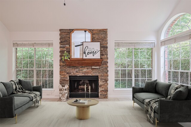 26 Skyland Pl, The Woodlands, TX 77381 - living area with lofted ceiling, a fireplace, and healthy amount of natural light