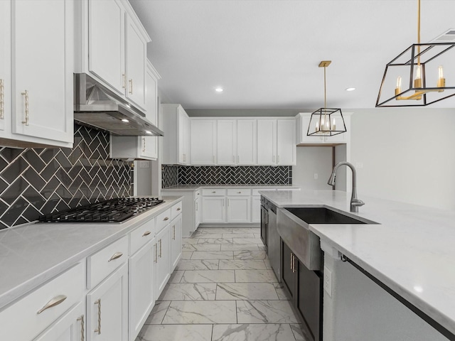 2107 Jitterbug Ln, Katy, TX 77493 - kitchen with light marble finish floors, a sink, stainless steel gas stovetop, under cabinet range hood, and white cabinets